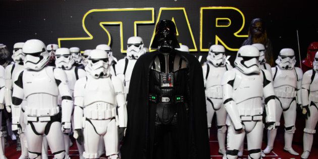 Actors dressed as Stormtroopers and Darth Vader pose for photographers upon arrival at the European premiere of the film 'Star Wars: The Force Awakens ' in London, Wednesday, Dec. 16, 2015. (Photo by Jonathan Short/Invision/AP)