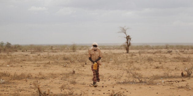 DADAAB, KENYA - JULY 19: A man walks with a water container on the outskirts in the Dagahaley refugee camp which makes up part of the giant Dadaab refugee settlement on July 19, 2011 in Dadaab, Kenya. The refugee camp at Dadaab, located close to the Kenyan border with Somalia, was originally designed in the early 1990s to accommodate 90,000 people but the UN estimates over 4 times as many reside there. The ongoing civil war in Somalia and the worst drought to affect the Horn of Africa in six decades has resulted in an estimated 12 million people whose lives are threatened. (Photo by Oli Scarff/Getty Images)