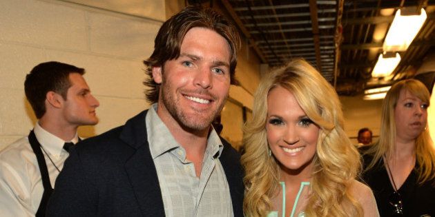 NASHVILLE, TN - JUNE 05: Singer Carrie Underwood (R) and Mike Fisher attend the 2013 CMT Music awards at the Bridgestone Arena on June 5, 2013 in Nashville, Tennessee. (Photo by Rick Diamond/Getty Images)