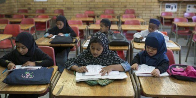 JOHANNESBURG, SOUTH AFRICA - SEPTEMBER 1: Muslim children receive education at Shaam ul-Islam Madrasa in Lenasia district of Johannesburg on September 1, 2015. Arabic grammar and literature, mathematics, logic, and natural science are studied in madrasahs in addition to Islamic theology and law. (Photo by Ihsaan Haffejee/Anadolu Agency/Getty Images)