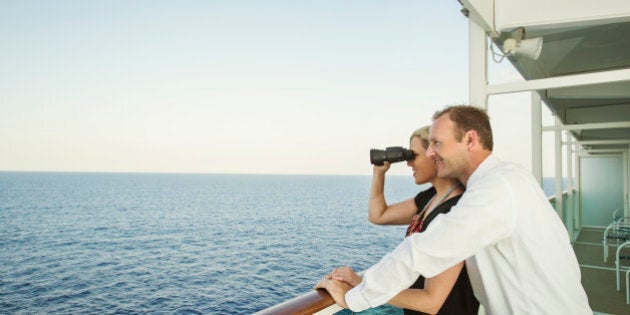 Caucasian couple admiring view from boat deck