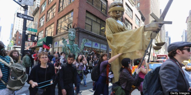 NEW YORK, NY - MAY 01: People march for immigrant workers rights as part of May Day rallies on May 1, 2013 in New York City. Rallies and marches are taking place throughout the city today to mark the day traditionally associated with workers movements. (Photo by Mario Tama/Getty Images)