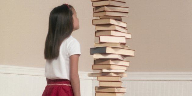 Girl by Stack of Books