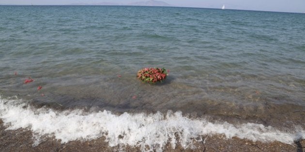 MUGLA, TURKEY - SEPTEMBER 4: Flowers are seen in the sea as people commemorate Aylan Kurdi, the three-year-old boy dressed in shorts and a red T-shirt, and 12 Syrians who drowned in the Aegean Sea after two boats filled with refugees en route to Greece sank, at the beach where they washed ashore in Mugla, Turkey on September 4, 2015. (Photo by Mustafa Ciftci/Anadolu Agency/Getty Images)