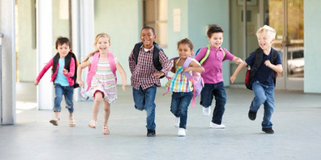 Group Of Elementary Age Schoolchildren Running Outside