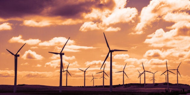 Wind turbine field at sunset, dramatic sky