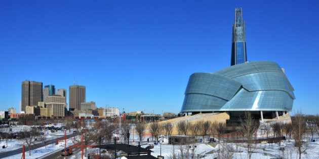 An urban cityscape of downtown Winnipeg, Manitoba under a big blue sky.