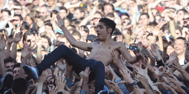 Sneazzy West, member of the French rap band 1995, is carried during a crowd surfing as part of the Francofolies music festival, in La Rochelle, western France, on July 15, 2012. AFP PHOTO / XAVIER LEOTY (Photo credit should read XAVIER LEOTY/AFP/GettyImages)