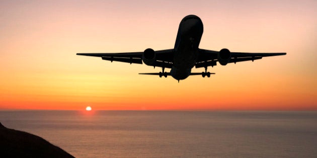 Airliner landing at sunrise