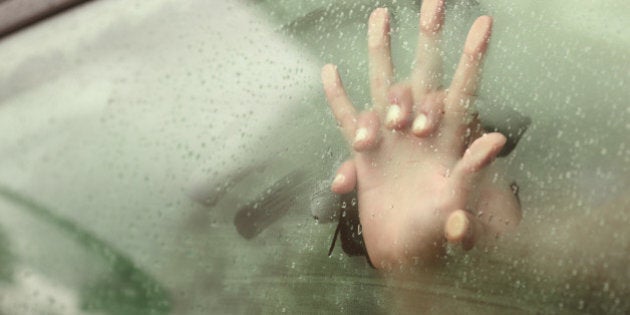 Couple holding hands having sex inside a car with a steamy window