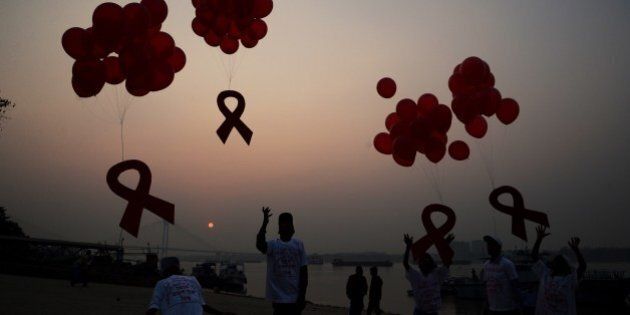 Indian social activists and children release ribbons and balloons during an event to mark World AIDS Day in Kolkata on December 1, 2014. According to the UN AIDS programme, India had the third-largest number of people living with HIV in the world at the end of 2013 and it accounts for more than half of all AIDS-related deaths in the Asia-Pacific region. In 2012, 140,000 people died in India because of AIDS. The Indian government has been providing free antiretroviral drugs for HIV treatment since 2004, but only 50 percent of those eligible for the treatment were getting it in 2012, according to a report by the World Health Organisation. AFP PHOTO/Dibyangshu SARKAR (Photo credit should read DIBYANGSHU SARKAR/AFP/Getty Images)