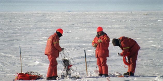 Workers gather seismic lines used for detecting the presence of natural gas and other underground deposits on the frozen Beaufort Sea, in Canada's Northwest Territories, March 20, 2002. Increasing U.S. demand, now backed by the Bush administration's desire for North American energy sources to reduce dependency on overseas supplies, is the main catalyst for Inuvik's recent growth spurt. (AP Photo/Tom Cohen)