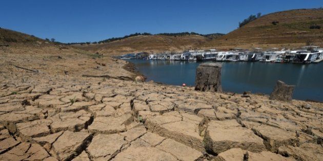 Dried mud and the remnants of a marina is seen at the New Melones Lake reservoir which is now at less than 20 percent capacity as a severe drought continues to affect California on May 24, 2015. California has recently announced sweeping statewide water restrictions for the first time in history in order to combat the region's devastating drought, the worst since records began. AFP PHOTO/ MARK RALSTON (Photo credit should read MARK RALSTON/AFP/Getty Images)