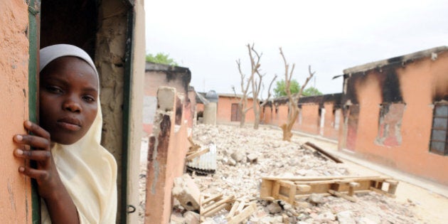 To go with AFP STORY: Fear pervades Nigerian city at heart of Islamist insurgency by M.J. Smith A female student stands in a burnt classroom at Maiduguri Experimental School, a private nursery, primary and secondary school burnt by the Islamist group Boko Haram to keep children away from school in Maiduguri, northeastern Nigeria May 12, 2012. The Nigerian Islamist group known as Boko Haram has grown from a northeastern-focused sect targeting local leaders and police to a many-headed monster capable of deploying suicide bombers to attack the United Nations, police headquarters and one of the country's most prominent newspapers. AFP PHOTO/PIUS UTOMI EKPEI (Photo credit should read PIUS UTOMI EKPEI/AFP/GettyImages)