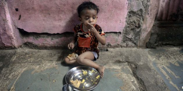 A malnourished Indian child finishes her lunch consisting of a special supplementary diet at the Nutrition Rehabilitation Centre (NRC) of Apnalaya - an Indian NGO providing nutritious free meals to children of manual scavengers and labourers from nearby slums at Govandi on the outskirts of Mumbai on April 18, 2013. India's parliament has passed a flagship 18-billion-dollar programme to provide subsidised food to the poor that is intended to 'wipe out' endemic hunger and malnutrition in the aspiring superpower. The Food Security Bill -- a key scheme seen as a vote-winner by the ruling Congress party ahead of national elections next year -- was adopted in the lower house after a nine-hour debate. AFP PHOTO/ INDRANIL MUKHERJEE (Photo credit should read INDRANIL MUKHERJEE/AFP/Getty Images)