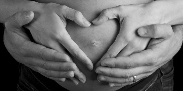 hands of pregnant woman and her ...