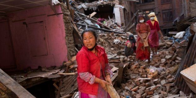 Nepalese women remove debris searching their belongings from their house that was destroyed a week ago during the earthquake in Bhaktapur, Nepal, Sunday, May 3, 2015. The true extent of the damage from the April 25 earthquake is still unknown as reports keep filtering in from remote areas, some of which remain entirely cut off. The U.N. says the quake affected 8.1 million people â more than a quarter of Nepal's 28 million people. (AP Photo/Bernat Amangue)