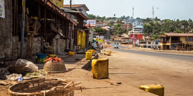 A usually busy street is deserted as Sierra Leone enters the second day of a three day country wide lockdown on movement of people due to the Ebola virus in the city of Freetown, Sierra Leone, Saturday, March 28, 2015. Guinea has deployed security forces to the country's southwest in response to reports that Sierra Leoneans are crossing the border to flee an Ebola lockdown intended to stamp out the deadly disease, an official said Saturday. (AP Photo/ Michael Duff)