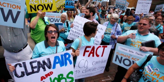 Some 300 environmental activists yell their support for stricter pollution rules proposed by the Environmental Protection Agency during a march to the William S. Moorhead Federal Building in downtown Pittsburgh by some 5000 union members, led by the United Mine Workers of America Thursday, July 31, 2014. Thursday is the first of two days of public hearings being held by the Environmental Protection Agency in Pittsburgh to discuss stricter pollution rules for coal-burning power plants proposed by the EPA. (AP Photo/Gene J. Puskar)