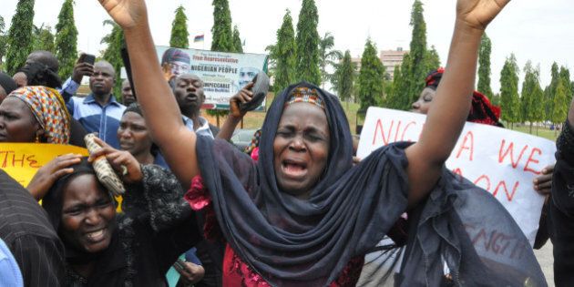 An unidentified mother cries out during a demonstration with others who have daughters among the kidnapped school girls of government secondary school Chibok, Tuesday April 29, 2014, in Abuja, Nigeria. Two weeks after Islamic extremists stormed a remote boarding school in northeast Nigeria, more than 200 girls and young women remain missing despite a ?hot pursuit? by security forces and desperate parents heading into a dangerous forest in search of their daughters. Some dozens have managed to escape their captors, jumping from the back of an open truck or escaping into the bush from a forest hideout, although the exact number of escapees is unclear. (AP Photo/ Gbemiga Olamikan)