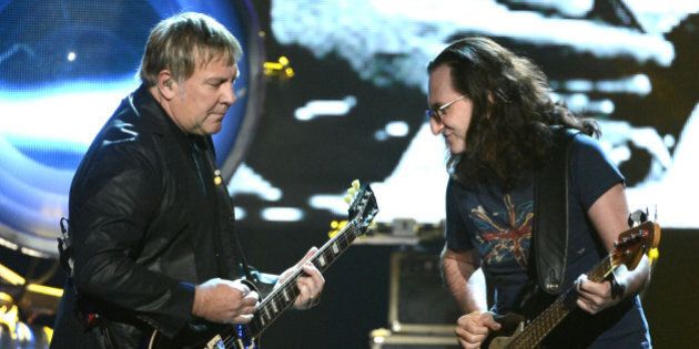 LOS ANGELES, CA - APRIL 18: Inductees Alex Lifeson and Geddy Lee of Rush perform on stage at the 28th Annual Rock and Roll Hall of Fame Induction Ceremony at Nokia Theatre L.A. Live on April 18, 2013 in Los Angeles, California. (Photo by Kevin Winter/Getty Images)