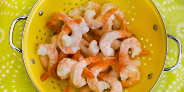 Frozen shrimps in a strainer bowl