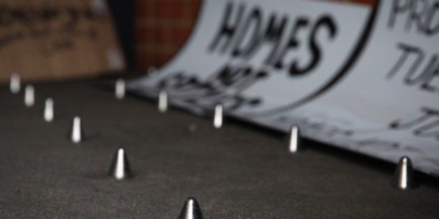 LONDON, ENGLAND - JUNE 09: A general view of a set of metal spikes outside a private block of residential flats on June 9, 2014 in London, England. The metal spikes which have recently been installed are believed to be to deter homeless people from sleeping in the alcove, which is situated outside a block of private flats in Southwark, London. (Photo by Dan Kitwood/Getty Images)