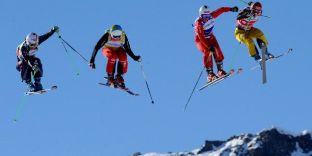 (FILES) A photo taken on December 15, 2013 shows (L-R) Norway's Marie Hoeie Gjefsen, Keisey Serwa, Katrin Mueller and France's Marie Berger Sabbatel competing during the FIS World Cup Women's Ski Cross event at the Val Thorens ski resort, French Alps. Some 26 years after freestyle skiiing has been shown as a demonstration sport at the 1988 Winter Olympic Games in Calgary, the halfpipe and ski slopestyle disciplines will make their Olympic debut at the 2014 Winter Olympics in Sochi. AFP PHOTO / JEAN-PIERRE CLATOT (Photo credit should read JEAN-PIERRE CLATOT/AFP/Getty Images)