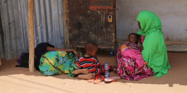 DADAAB, KENYA - OCTOBER 12: This photo taken on October 4, 2014 shows two refugee women resting with their children at Dadaab refugee camp in Kenya, the largest refugee complex in the world, where thousands of Somalis, Tanzanians, Sudanese and Ethiopians fleeing conflicts in their countries have found shelter and live under tough living conditions. (Photo by Cem Genco/Anadolu Agency/Getty Images)