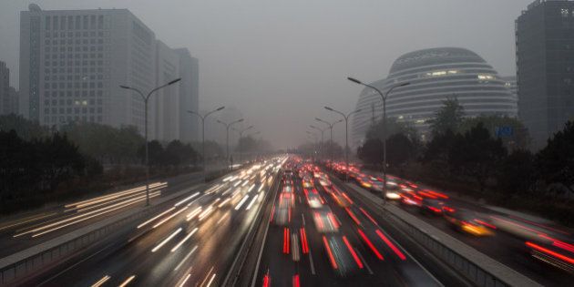 BEIJING, CHINA - NOVEMBER 29: Vehicles run in Second Ring Road of Beijing in smog. United States President Barack Obama and China's president Xi Jinping agreed on a plan to limit carbon emissions by their countries, which are the world's two biggest polluters, at a summit in Beijing earlier this month. on November 29, 2014 in Beijing, China. (Photo by Xiao Lu Chu/Getty Images)