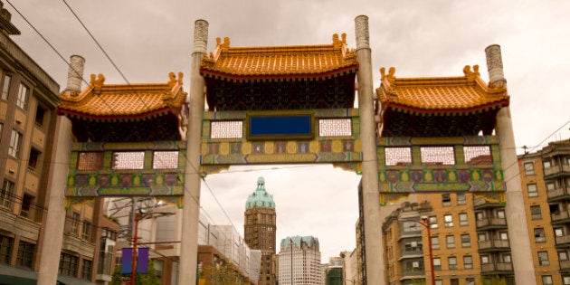 Pender Street leading through the Millennium Gate in Vancouver Chinatown with the Sun Tower in the background.