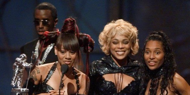 Left Eye, second left, T-Boz, center, and Chili, right, of the group TLC accept their award for best group video for their song