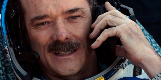 Canadian astronaut Chris Hadfield, speaks on cell phone shortly after the landing of the Russian Soyuz TMA-07 space capsule about 150 km ( 90 miles) south-east of the Kazakh town of Dzhezkazgan, Tuesday, May 14, 2013. A Soyuz space capsule with a three-man crew returning from a five-month mission to the International Space Station landed safely Tuesday on the steppes of Kazakhstan. (AP Photo/Mikhail Metzel, Pool)