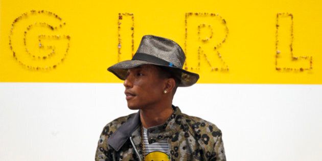 Singer Pharrell Williams poses during a news conference for the exhibition