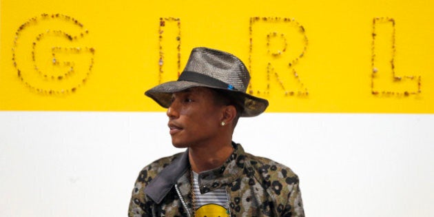 Singer Pharrell Williams poses during a news conference for the exhibition