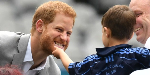 The Duke of Sussex has his beard stroked by a small child in Croke Park on the second day of his visit...