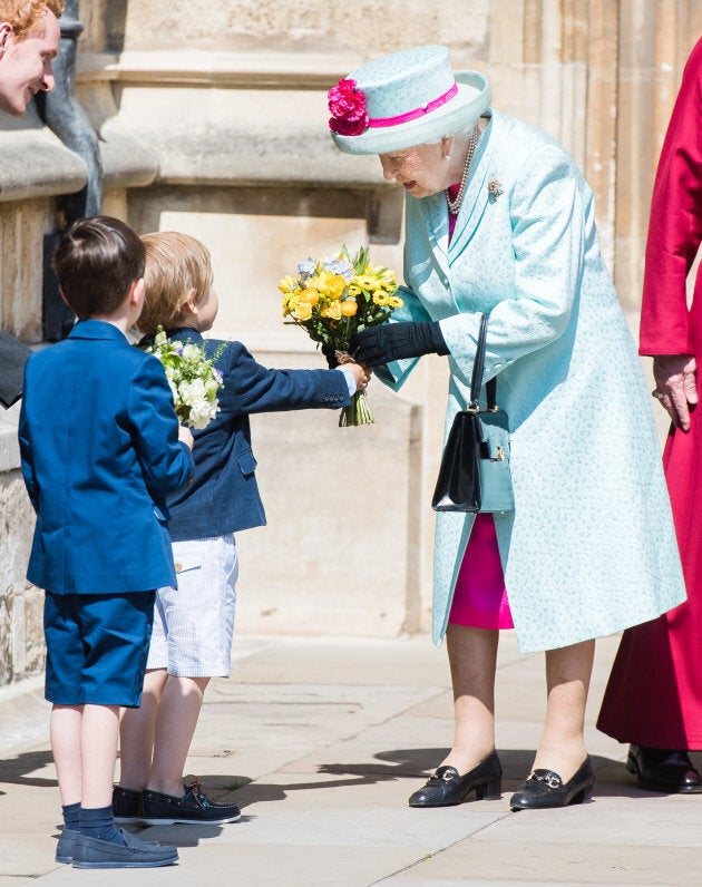 Queen Elizabeth II receives flowers at the Easter Sunday service at St George's Chapel.