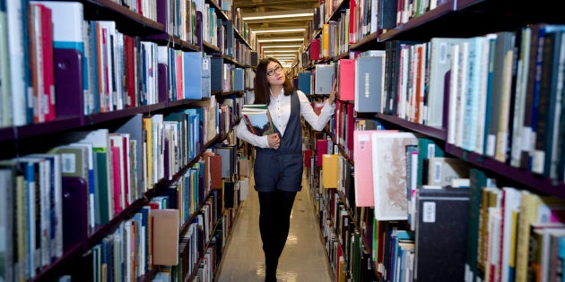 File photo of a woman browsing books at a library.