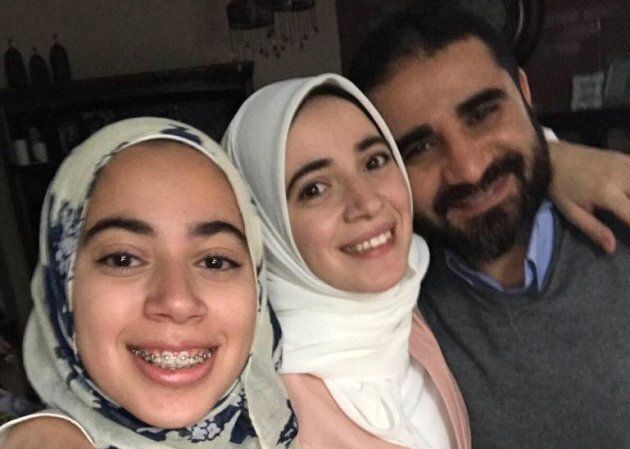 Amal Ahmed Albaz, centre, is photographed with her sister Maryam and father Yasser.