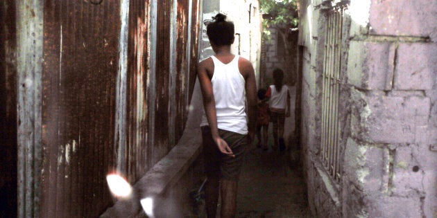 Children walk down an alley in Manila, where Philippine National Police had searched on April 2, 2019, for victims of online sexual abuse.