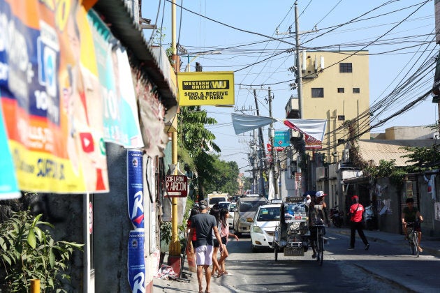 Filipinos abroad routinely send money home through money transfer companies like Western Union, seen here in a low-income community of Manila.