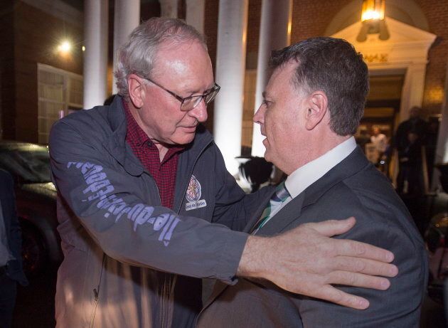 P.E.I. Premier Wade MacLauchlan, left, greets Progressive Conservative leader Dennis King in Charlottetown after King's Tories won the province's election on April 23, 2019.