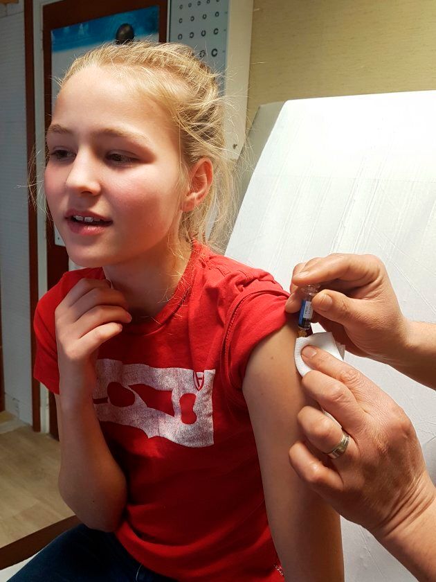 A teen is injected with Repevax, a vaccination for diphtheria, polio and pertussis.