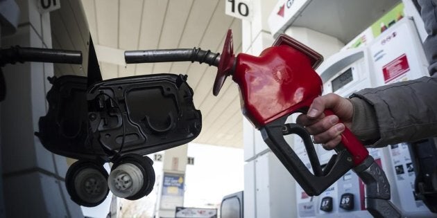A woman fills up her with gas in Toronto, on April 1, 2019.