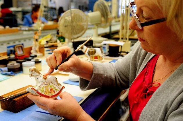 Julie Scott puts the final touches on a rocking horse, a souvenir to commemorate the birth of the Prince George, at Royal Crown Derby in 2013.
