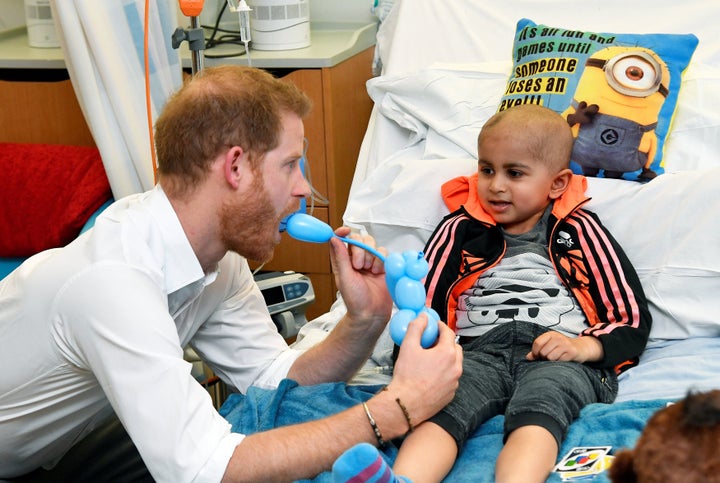 The Duke of Sussex plays with a patient as he visits the Oxford Children's Hospital in Oxford on May 14. His visit highl