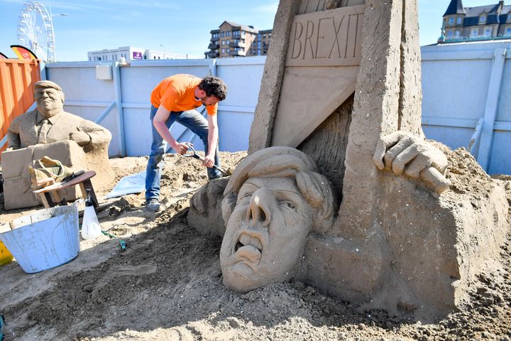 Artist Johannes Hogebrink and his sand sculpture of Theresa May 