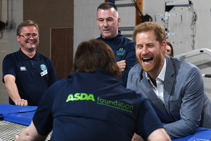 Prince Harry interacts with a participant of the Rebound Therapy session as he visits the Oxsrad Disability Sports and Leisure Centre on May 14.