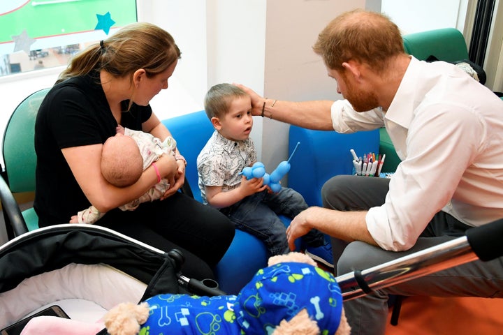 The duke visiting with some of the children at the hospital. 