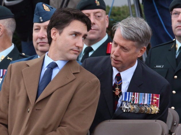 Justin Trudeau speaks with Andrew Leslie prior to a ceremony at the National War Memorial in Ottawa on Oct. 22, 2015